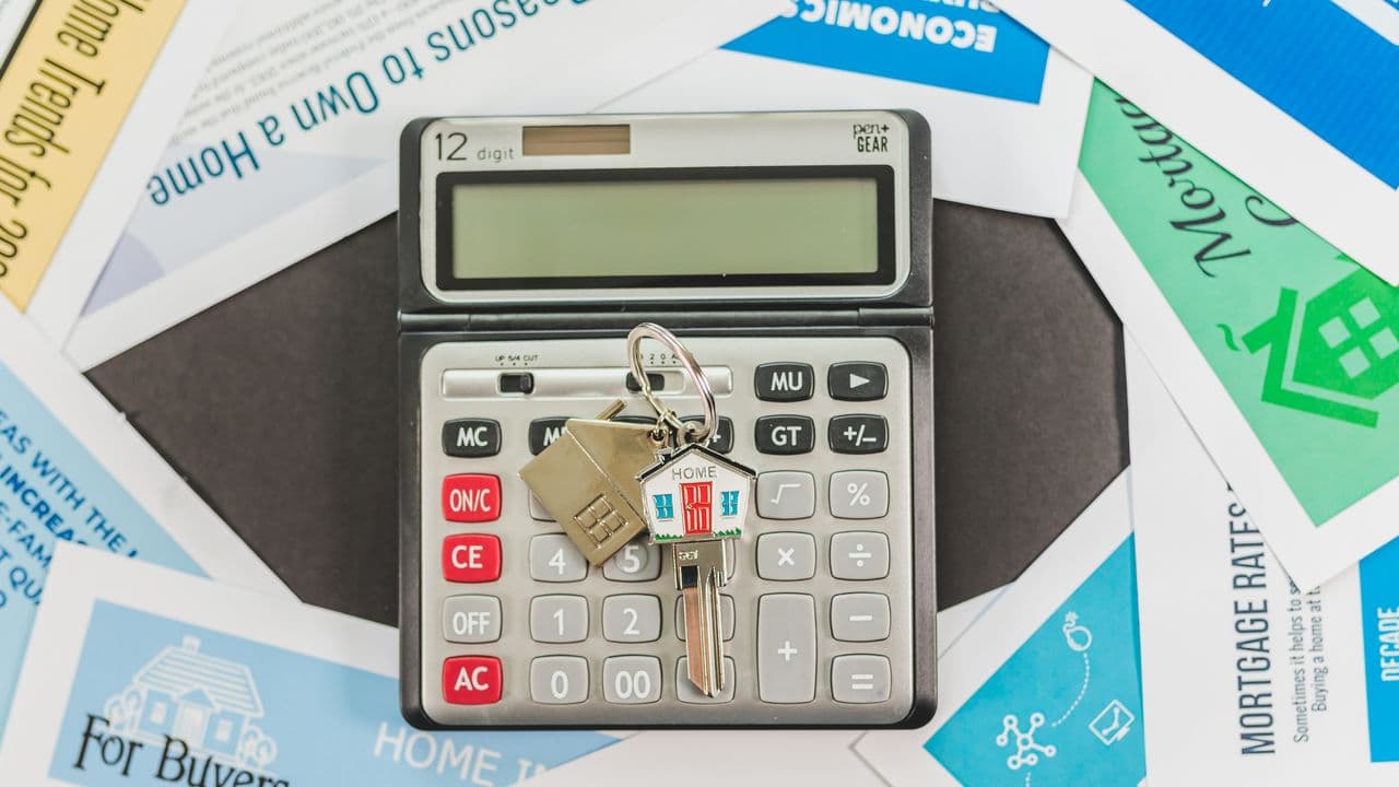 Calculator on a table beside planning materials