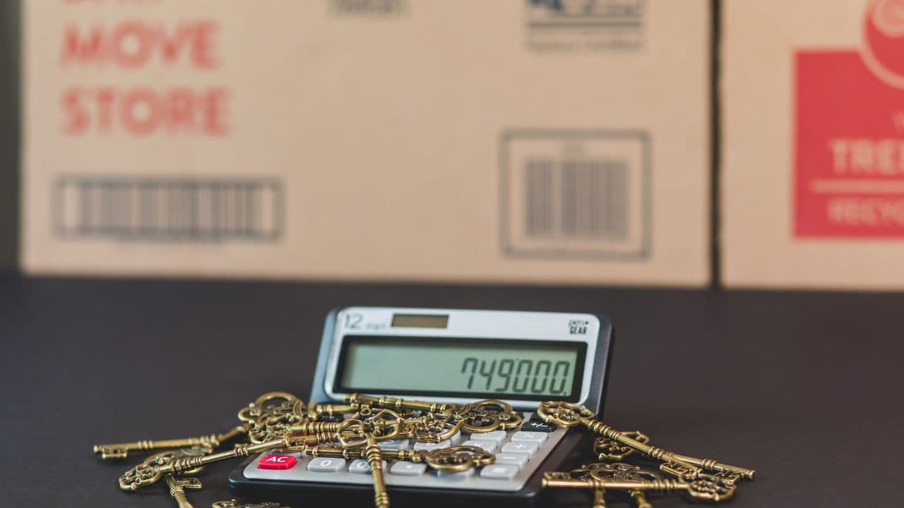 House keys resting on a calculator